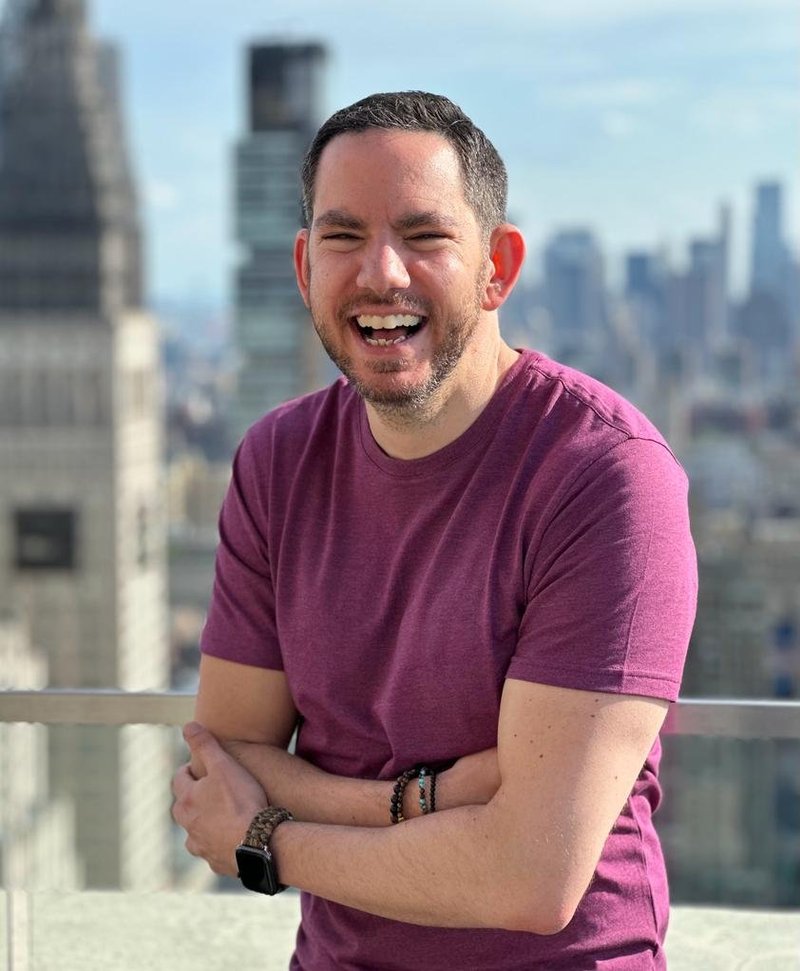 Lylan Masterman on a New York City rooftop with the Manhattan skyline